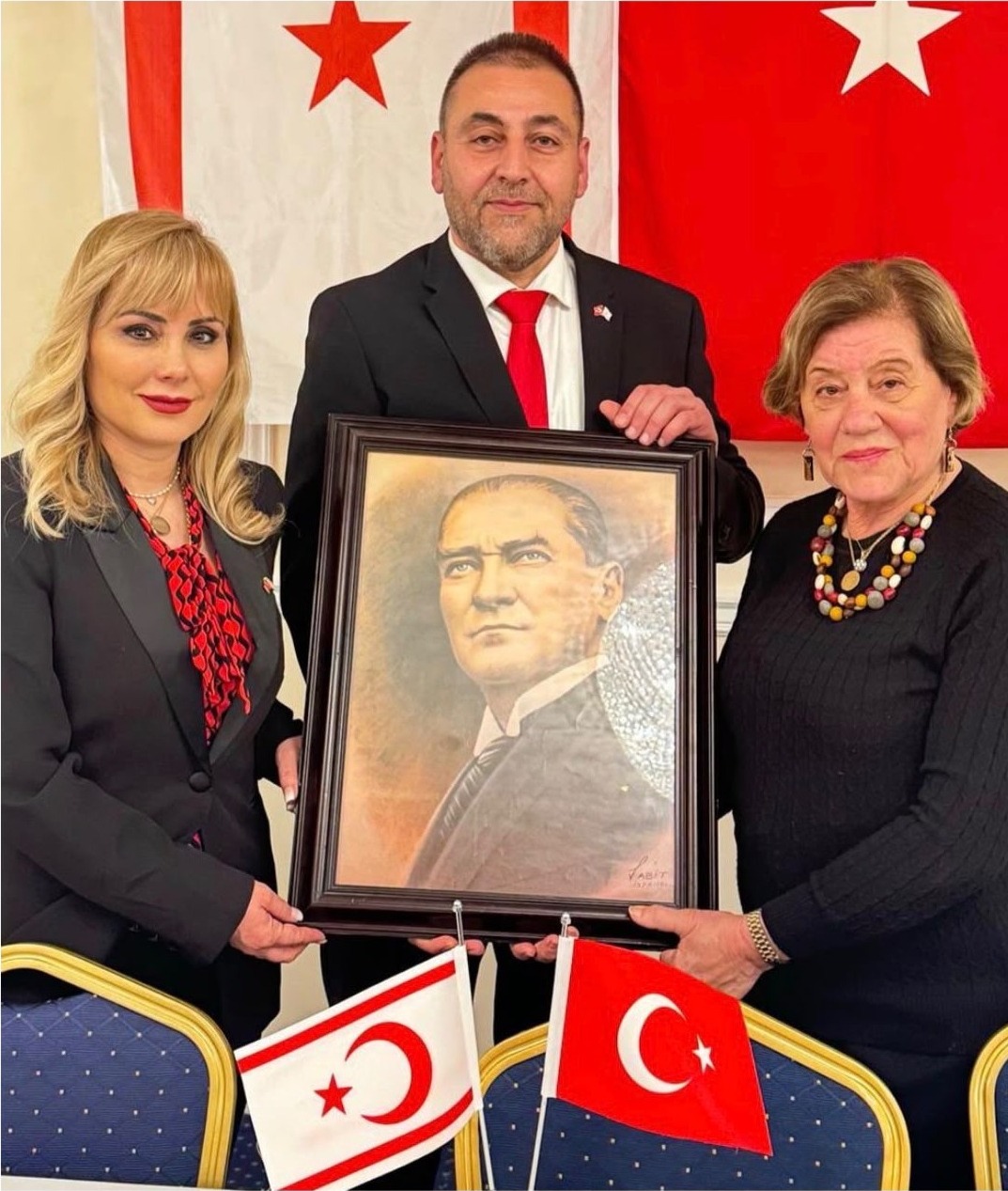 Committee members presenting a framed Atatürk portrait